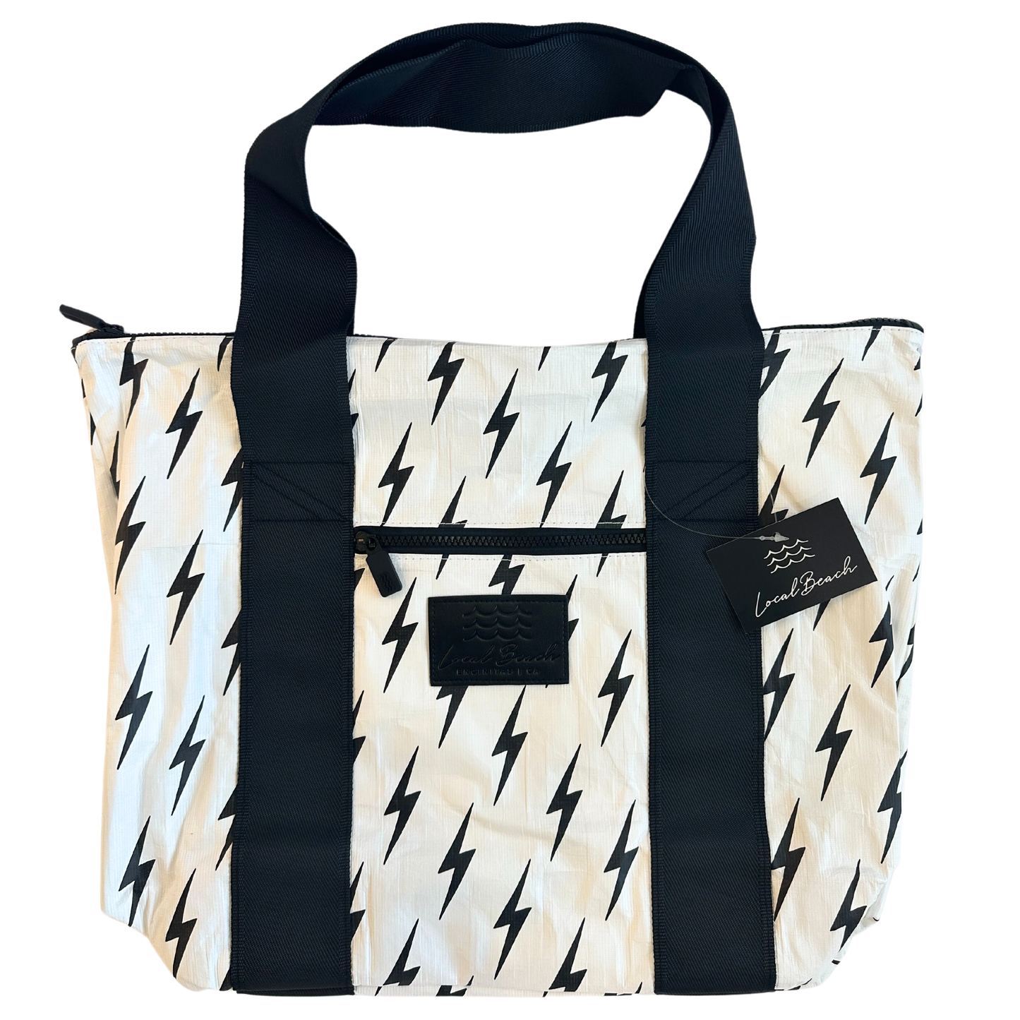 Tote bag with black and white pattern and visible brand tag on a white background