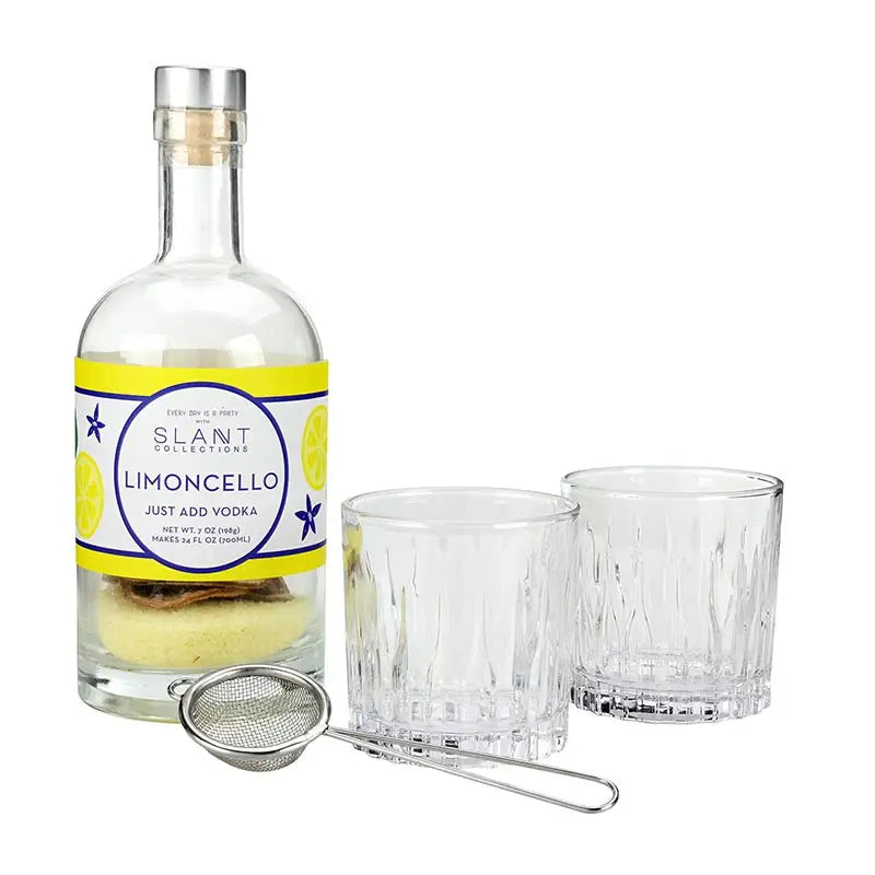 Slant Limoncello bottle with two glasses and a strainer on a white background