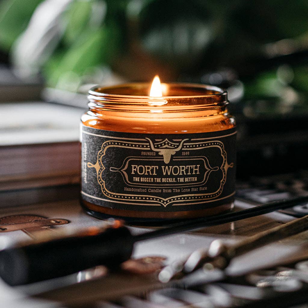 Candle in a jar labeled 'Fort Worth' with a blurred background