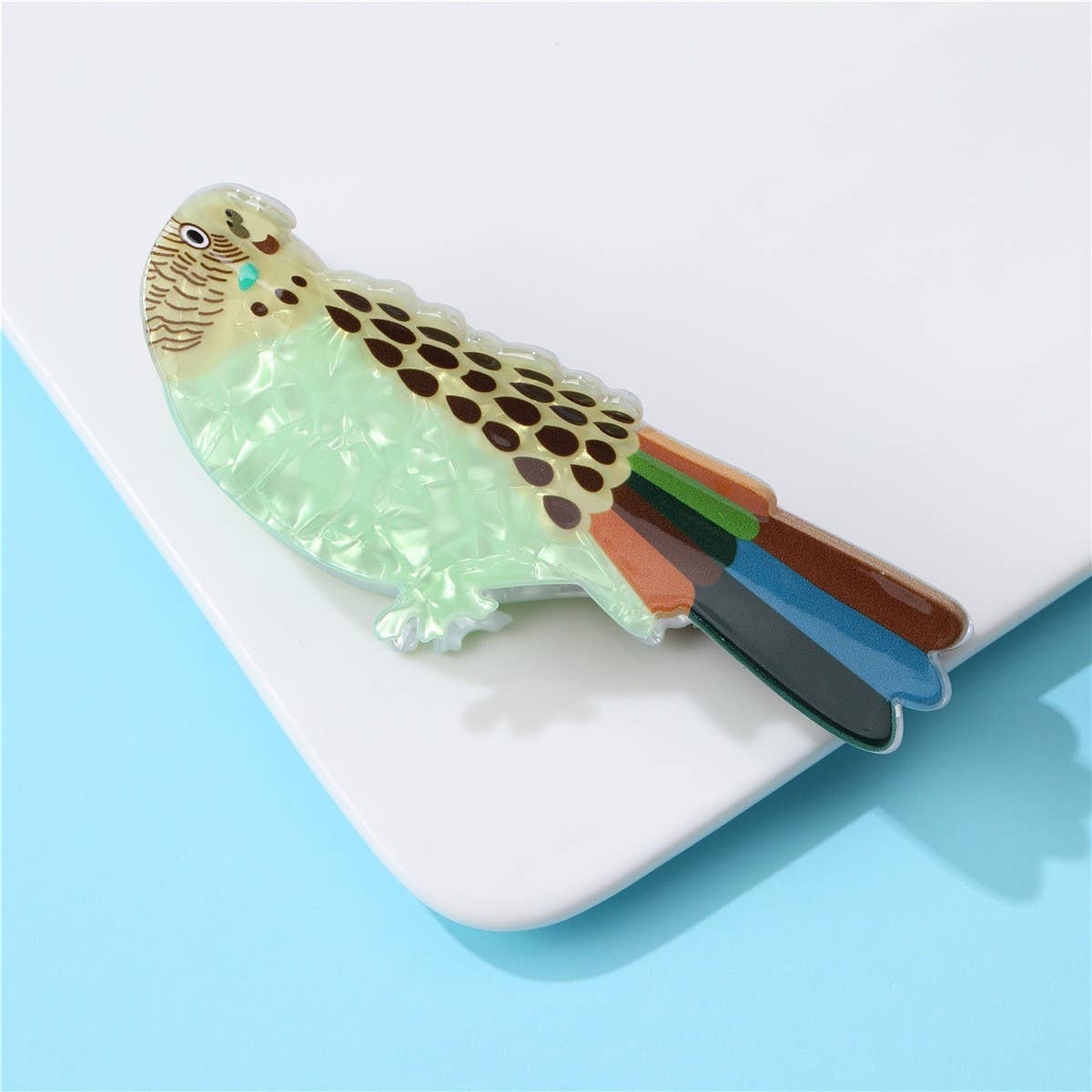 Bird-shaped stationery item on a light blue background