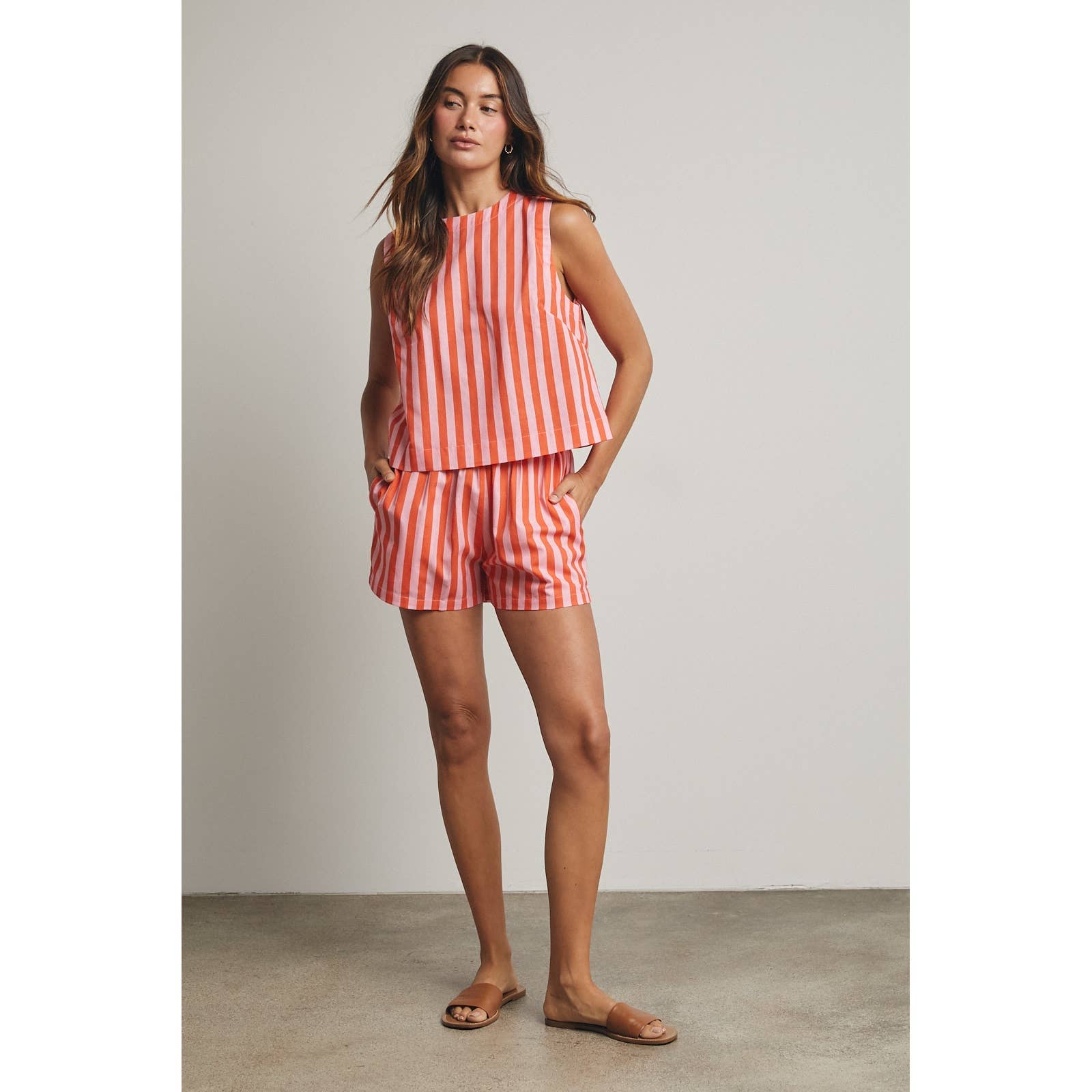 Woman wearing an orange and pink striped outfit 