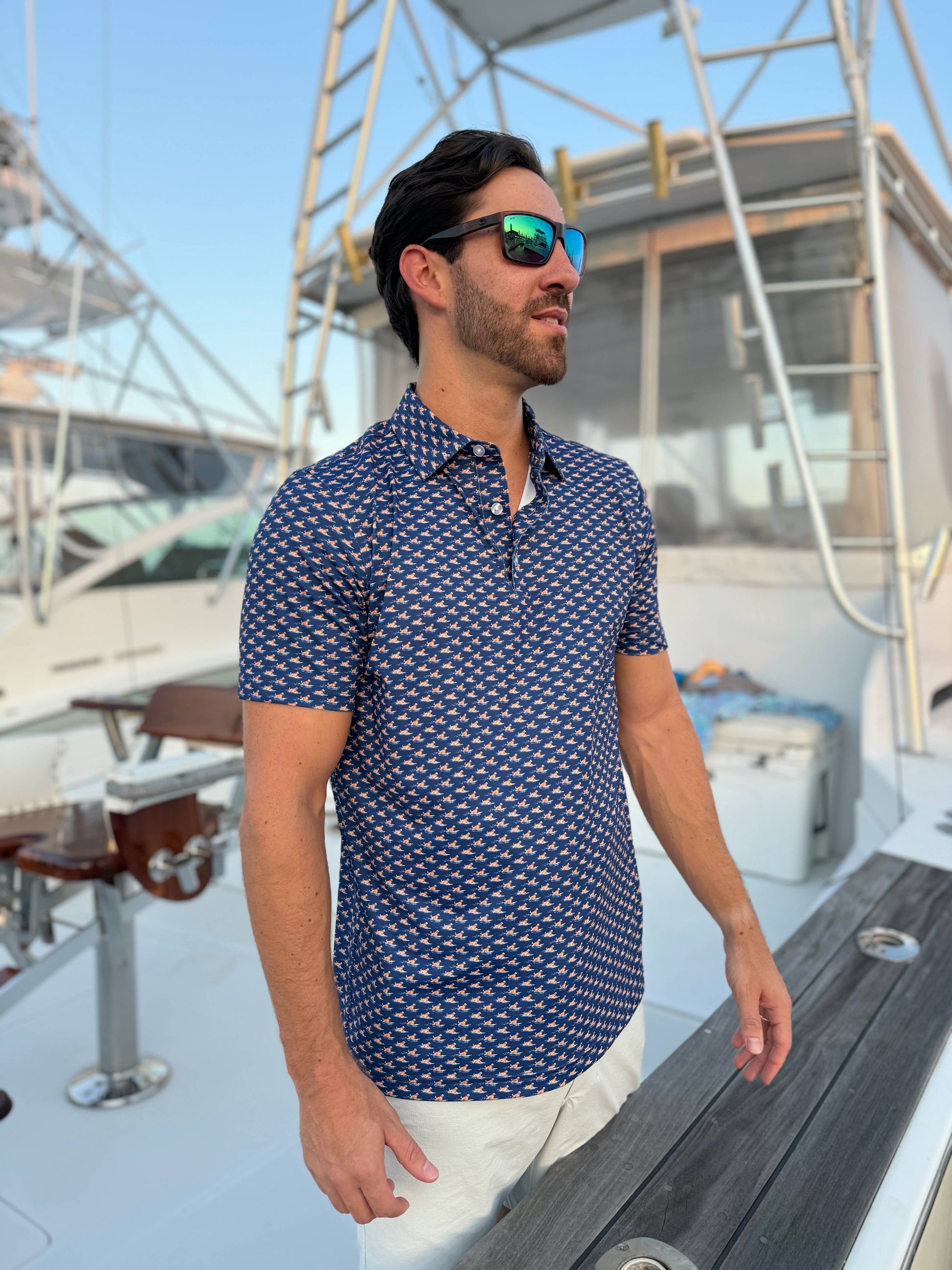 Man wearing a blue patterned shirt on a boat