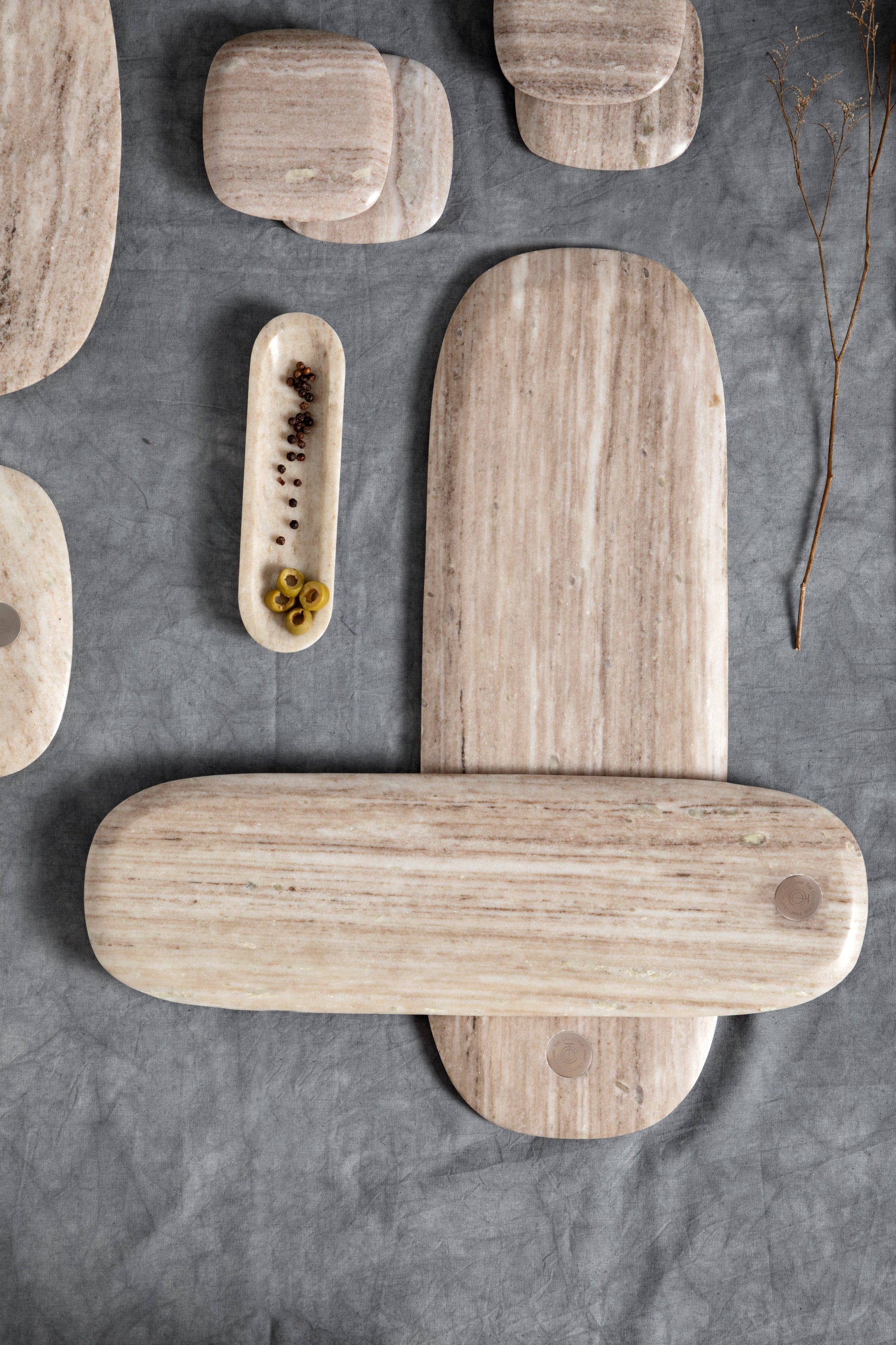 marble cutting boards of various sizes on a gray surface