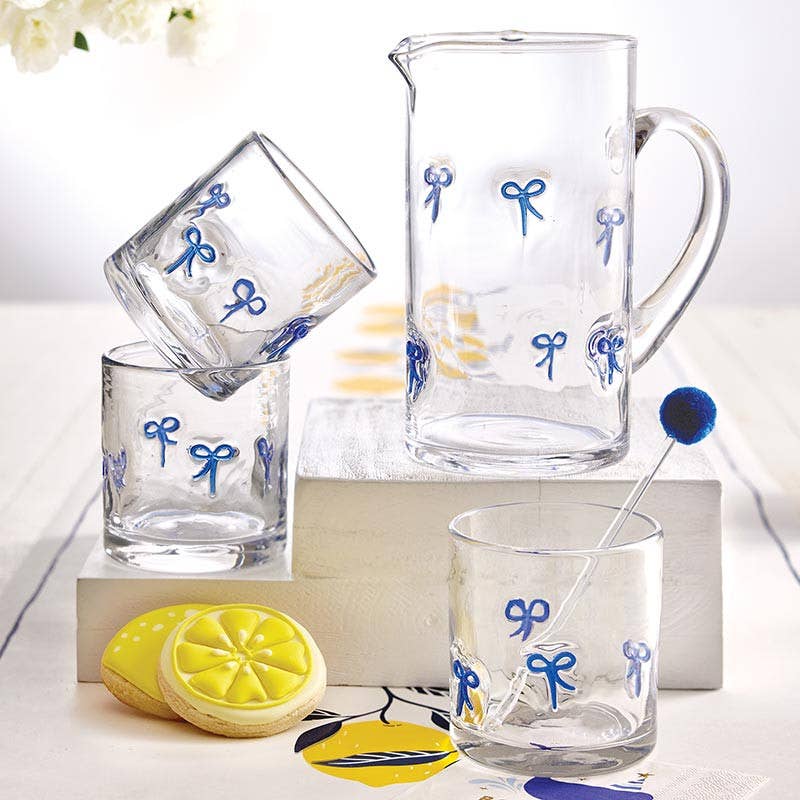 Clear glass pitcher and glasses with blue bow designs