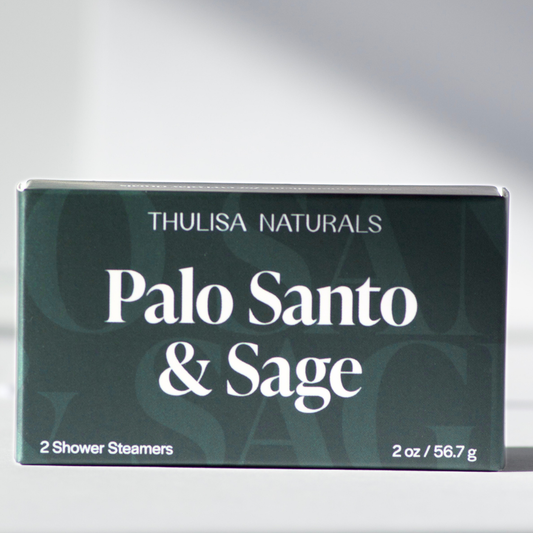 Box of Thulisa Naturals Palo Santo & Sage shower steamers on a gray background