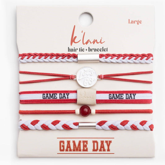 Set of red and white hair ties and bracelets on a 'káóliá' branded card.