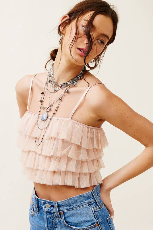 Woman wearing a layered ruffle top and jeans 