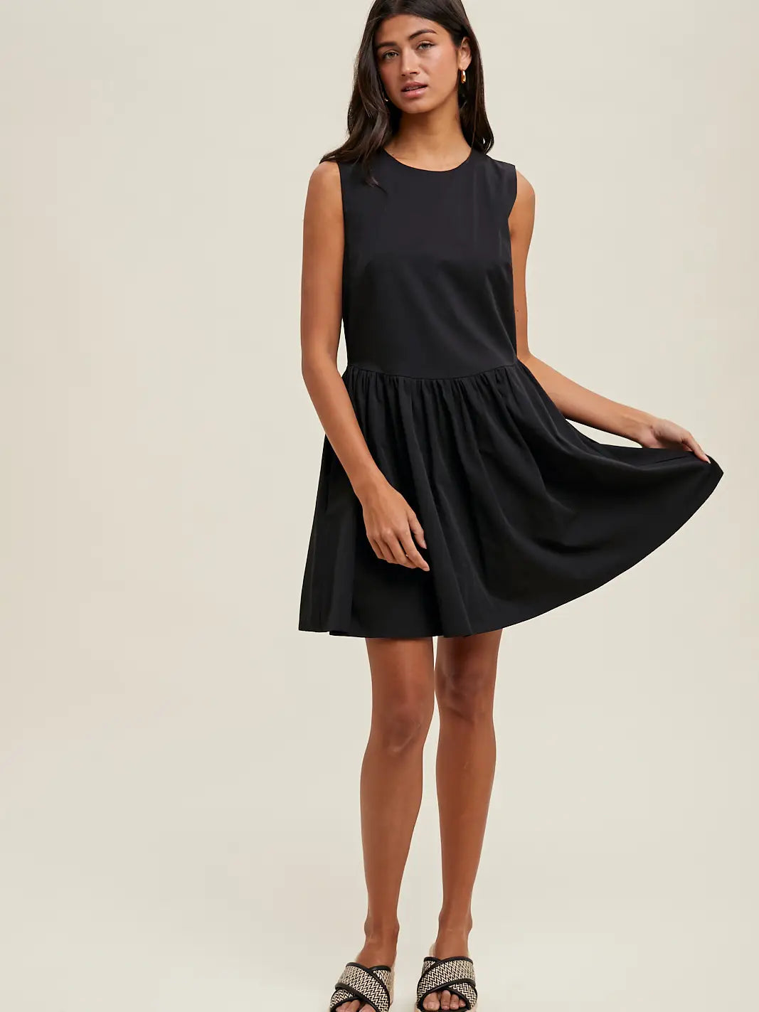 Woman wearing a black sleeveless dress 