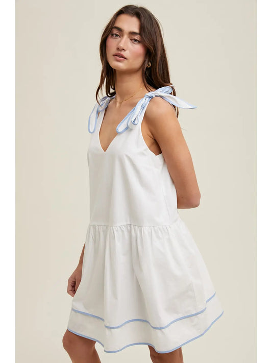 Woman wearing a white dress with blue accents 