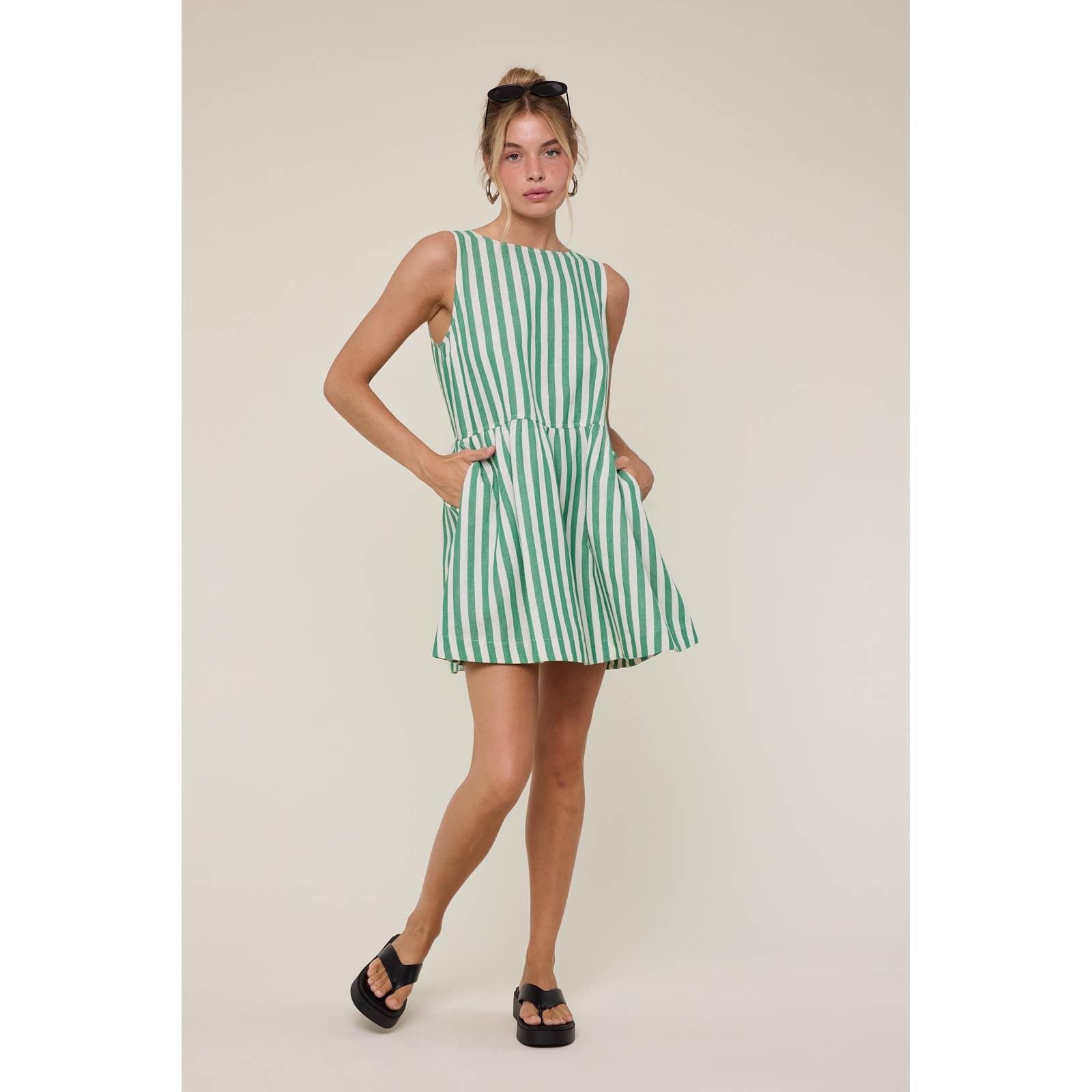 Woman wearing a green and white striped dress 