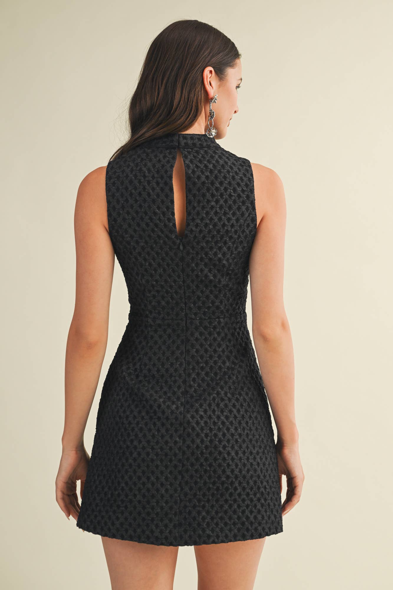 Black patterned dress worn by a model 