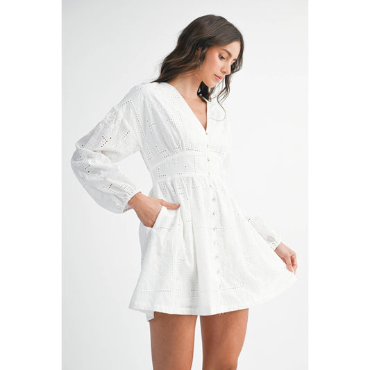Woman wearing a white dress with long sleeves 