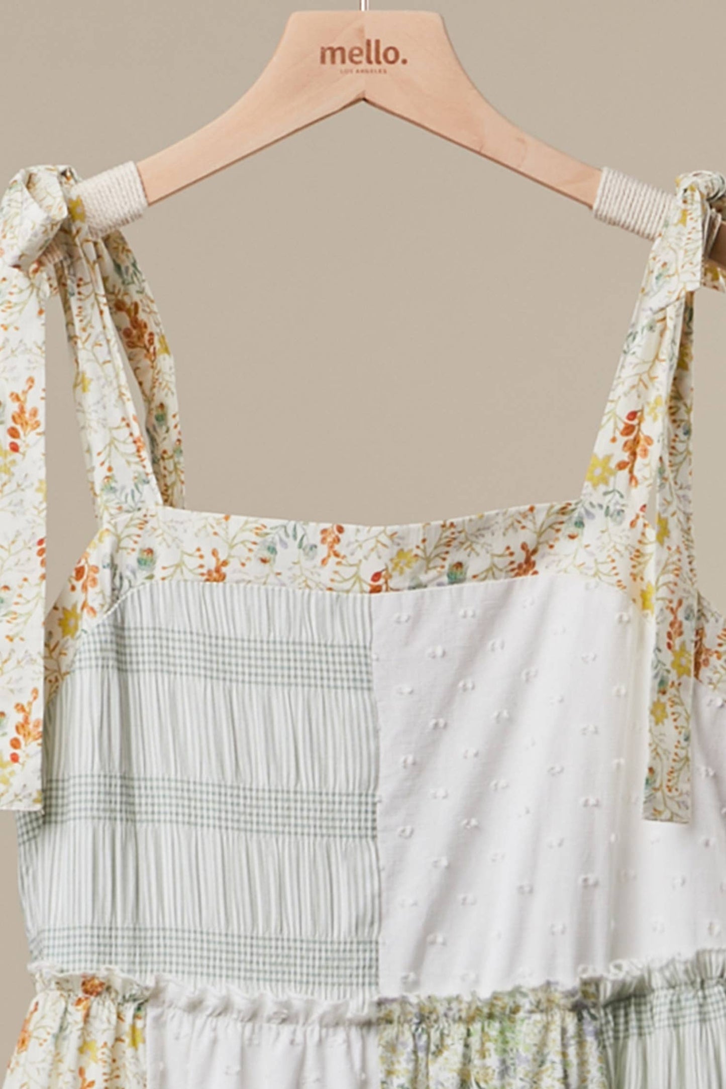 Floral and plaid dress on a hanger with 'mello' brand visible