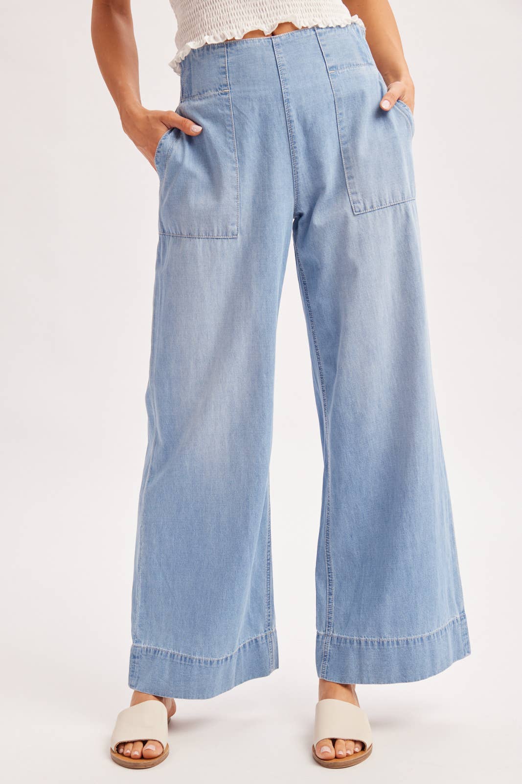 Light blue denim wide-leg pants worn by a person on a white background