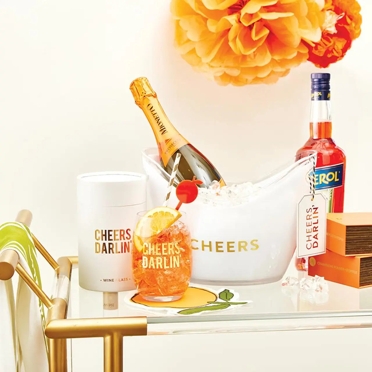 Alcohol-themed table setting with bottles, glasses, and decorative elements on a white surface.