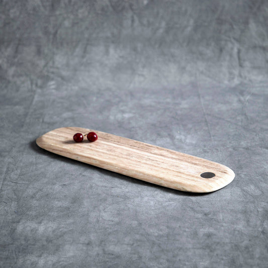 Marble cutting board with a hole on a gray surface