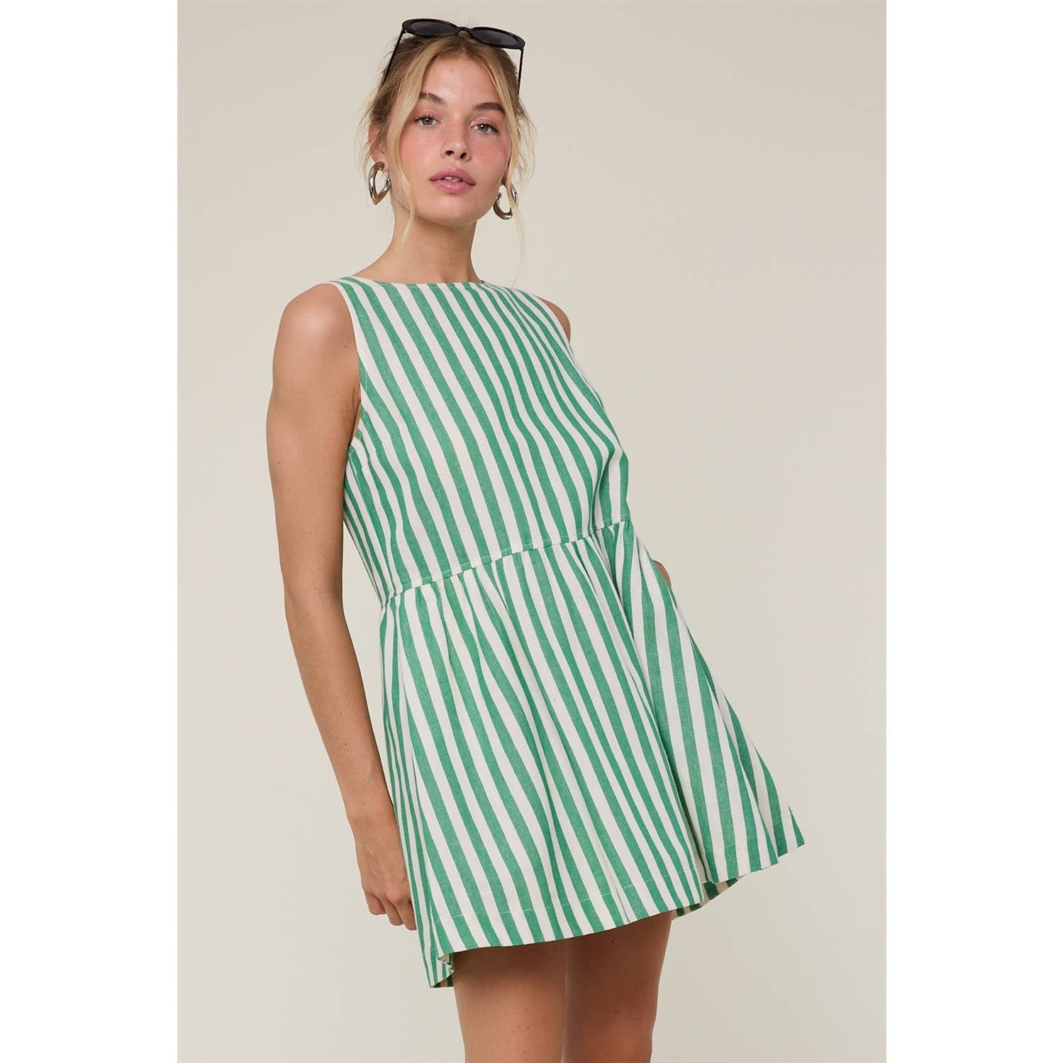 Woman wearing a green and white striped dress
